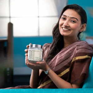 woman-saree-smiling-while-holding-money-glass-jar-hand woman-saree-smiling-while-holding-money-glass-jar-hand
